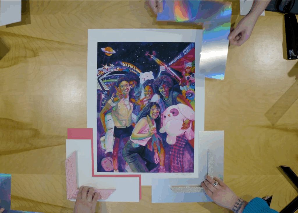A painting on a table surrounded by different frames.
