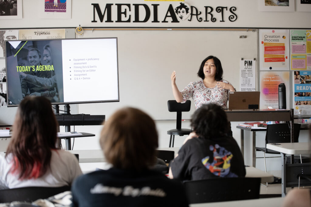 Woman speaking in front of a classroom