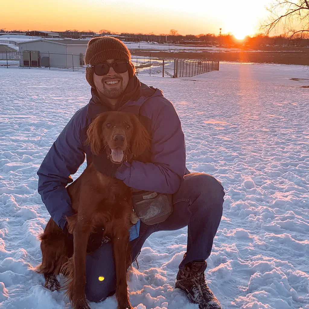 Man smiling at camera with dog