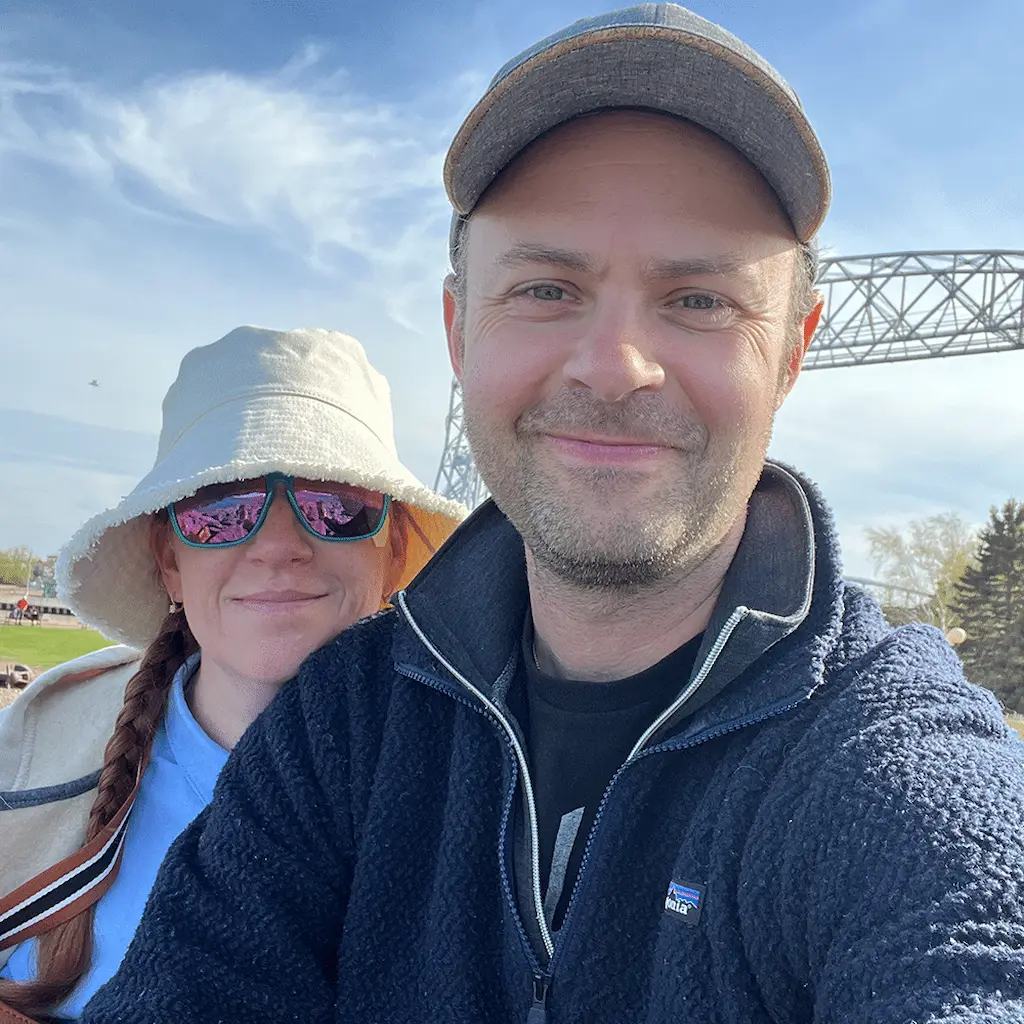 Man and woman outside smiling at the camera