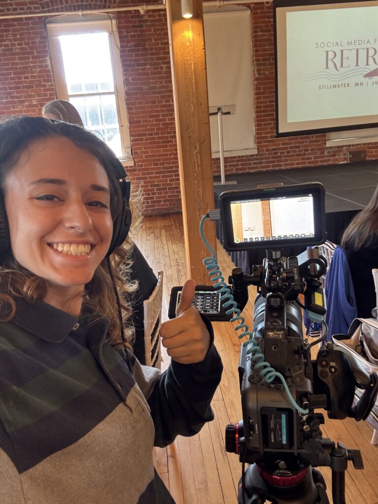 Xandra smiling with her camera set up